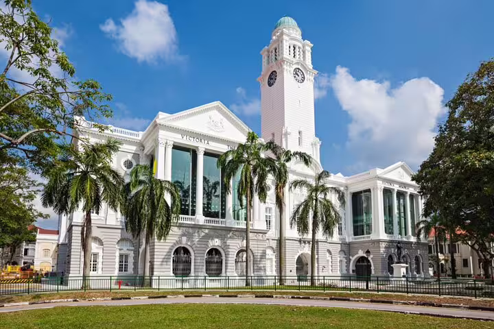 Victoria Theatre and Concert Hall white colonial building with clock tower and palm trees, Singapore