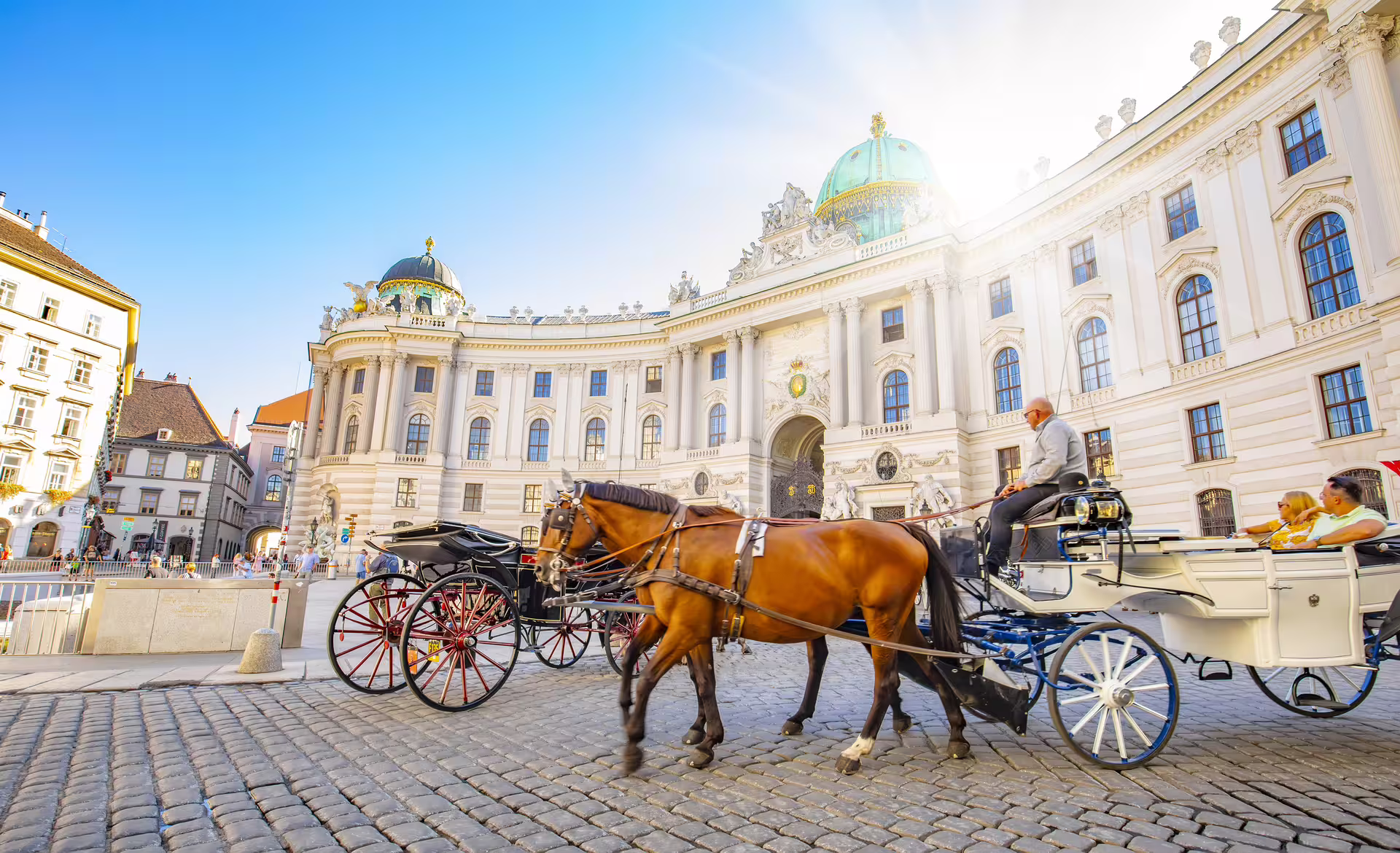 Horse-drawn fiaker at Hofburg Palace, Vienna, on a 1-day cultural heritage walking tour with audioguide