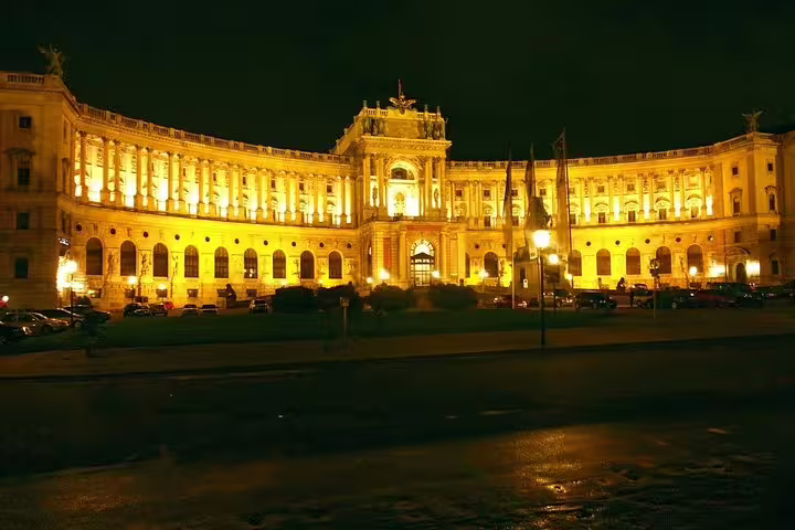 Vienna's Hofburg Palace illuminated at night, showcasing its majestic architecture for a private sightseeing tour.