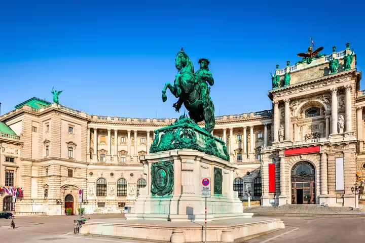 Equestrian statue at Hofburg Palace square in Vienna, Austria under clear blue sky
