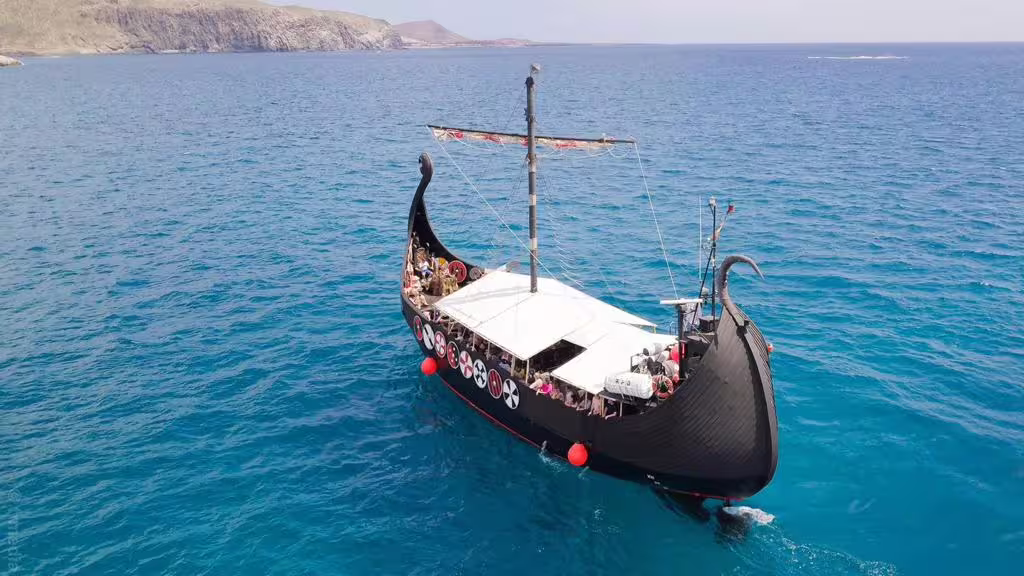 Aerial view of Viking ship cruising through blue waters, ideal for 2-hour whale and dolphin watching tour.