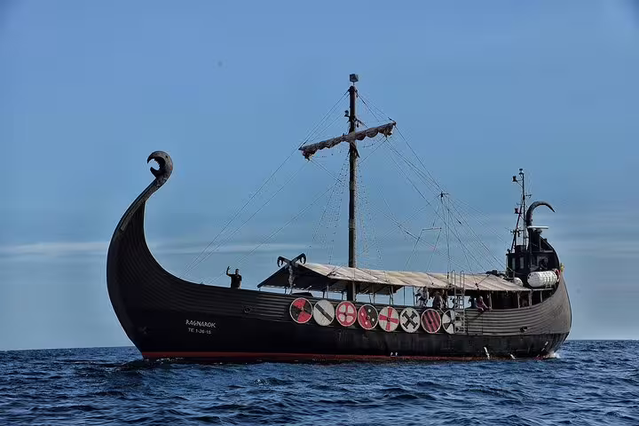 Authentic Viking longship cruising on open sea, perfect for a unique adventure with drinks and swimming.