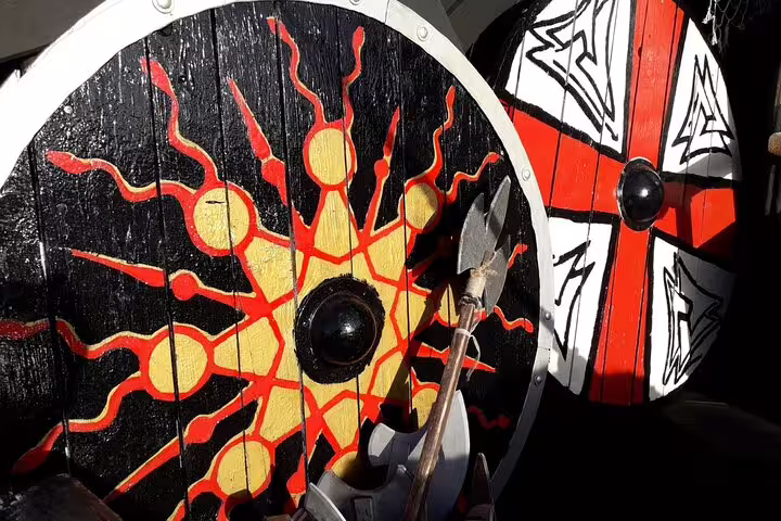 Close-up of colorful Viking shields and spear, enhancing the historical theme of the 2h Viking Cruise.