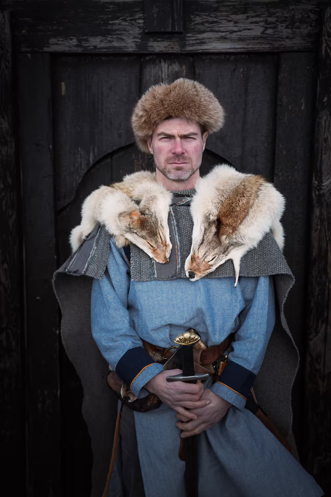 Viking warrior in authentic fur costume with sword at Southeast Iceland Viking Journey historical experience