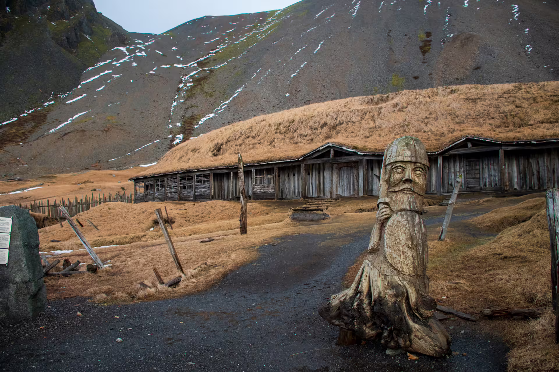 Wooden Viking warrior sculpture at historic Norse longhouse village in Southeast Iceland Viking journey tour