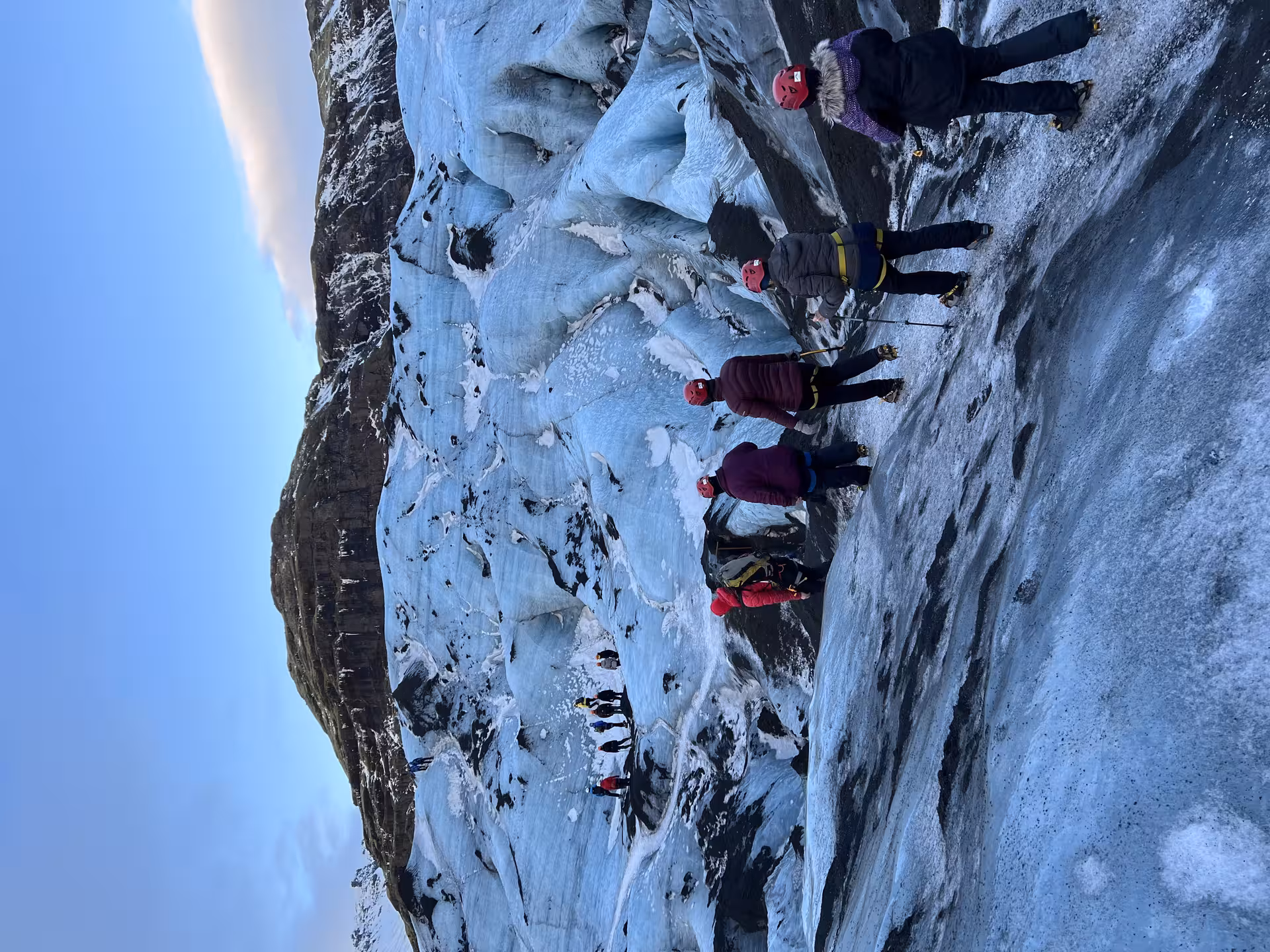 Women adventurers exploring icy glacier terrain during a 7-day festive winter adventure with Viking Women.