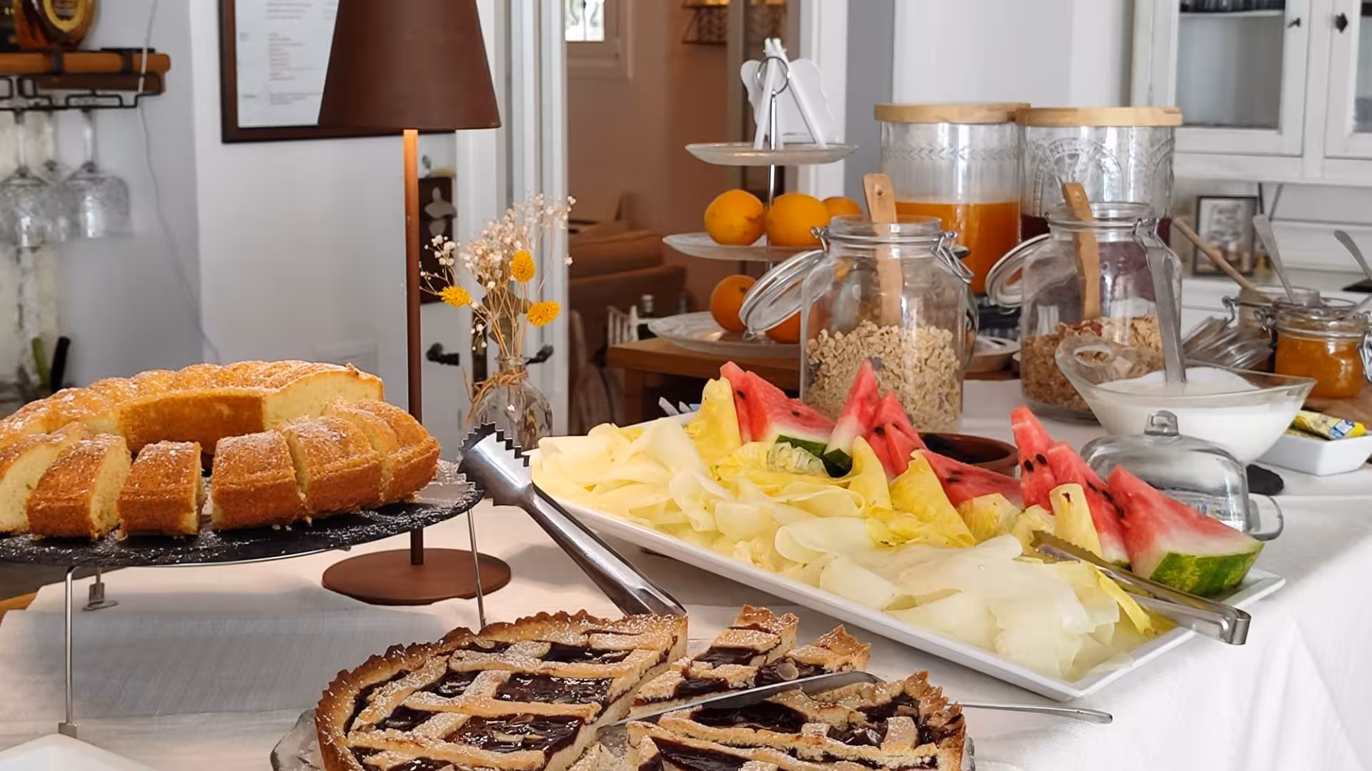 Lavish breakfast spread with fresh fruit, pastries, and juices at a villa retreat for a relaxing day.