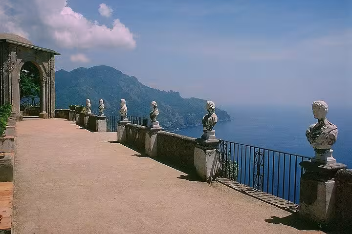Marvel at the stunning coastal views and classical sculptures on the terrace of Villa Cimbrone, Ravello.