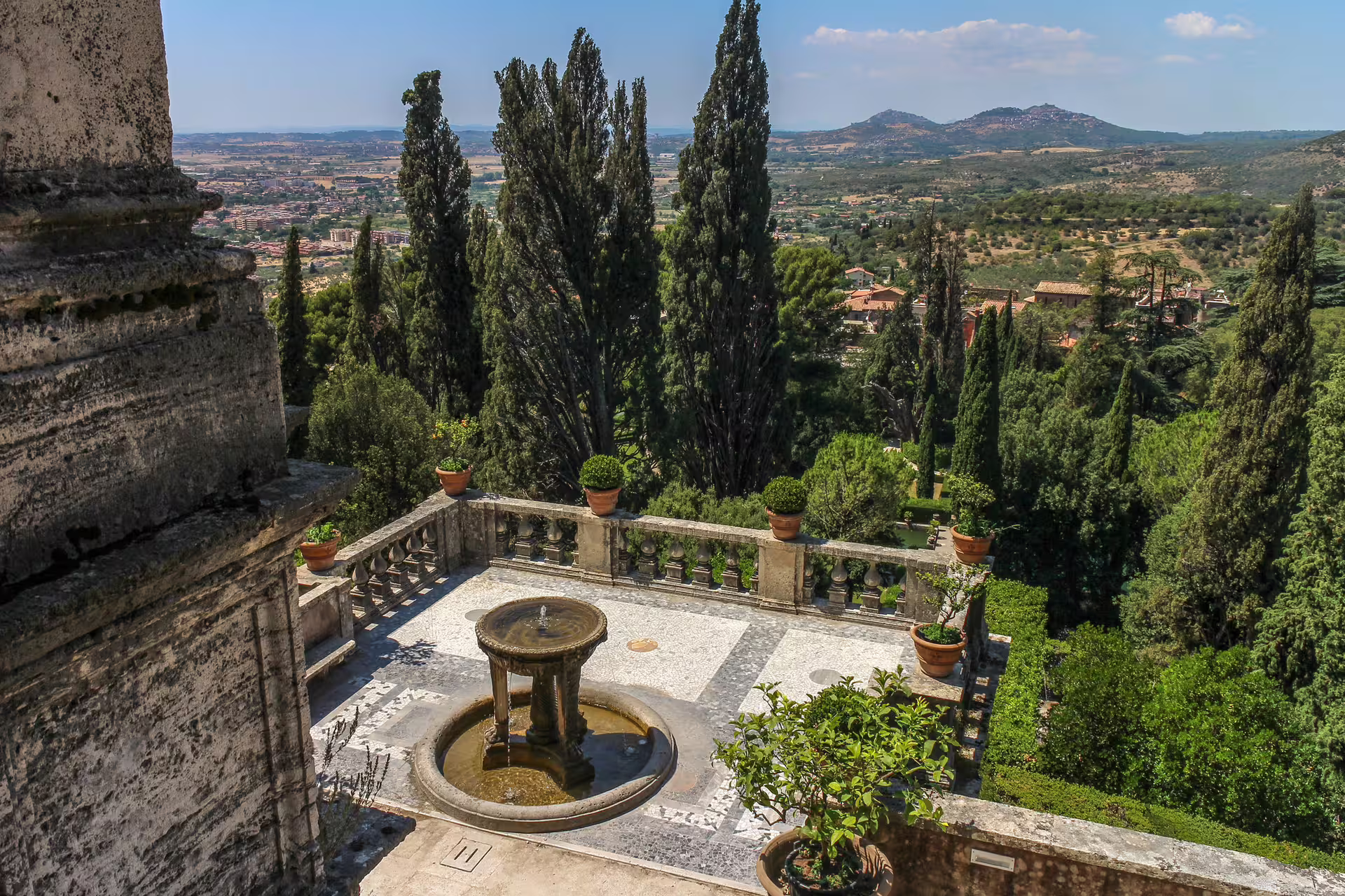 Terrace fountain and cypress-lined gardens of Villa d’Este in Tivoli with sweeping views of the Roman countryside
