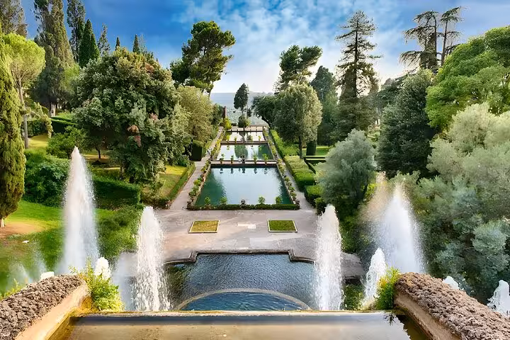 Panoramic view of Villa d'Este's majestic gardens in Tivoli, featuring elegant fountains and verdant landscapes.