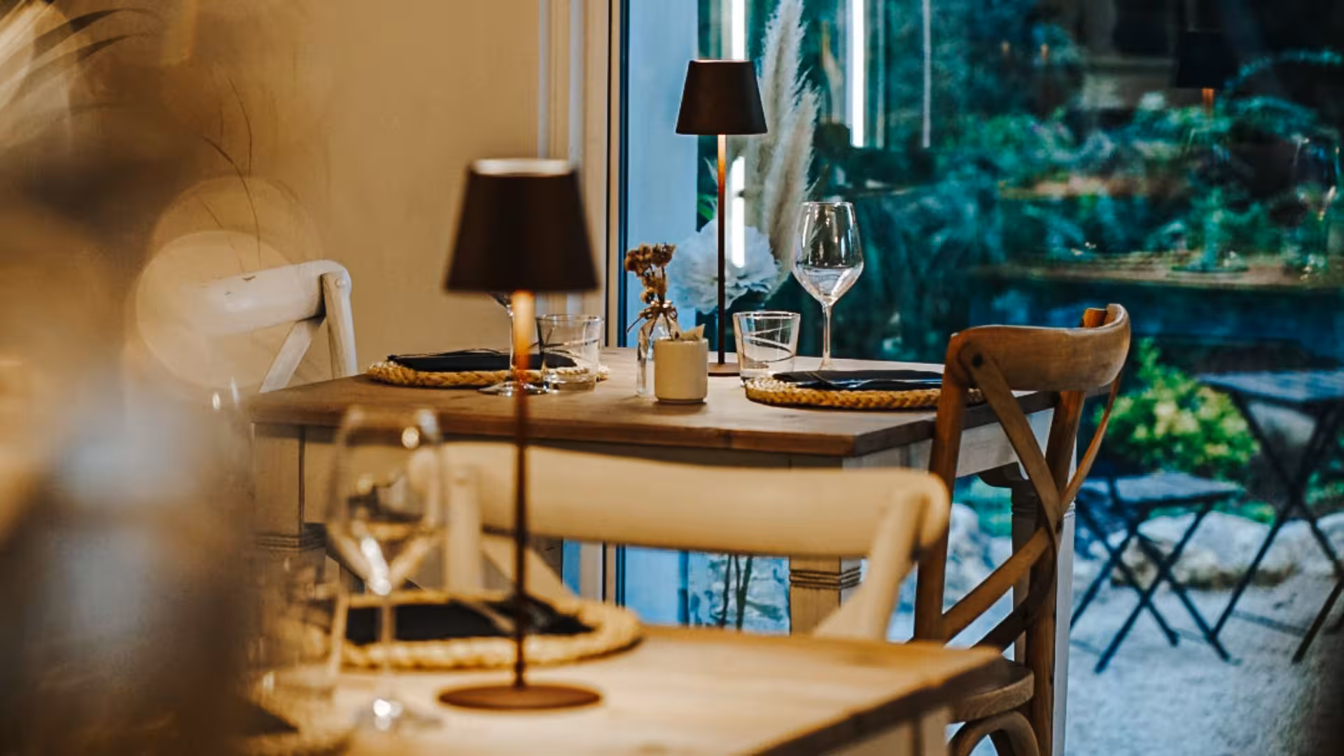 Cozy villa dining setup with elegant tableware and a view of lush gardens, perfect for a relaxing afternoon.