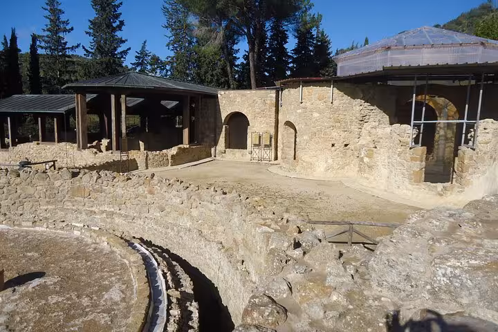 Ancient stone architecture of Villa Romana del Casale with surrounding greenery in Piazza Armerina, Sicily.