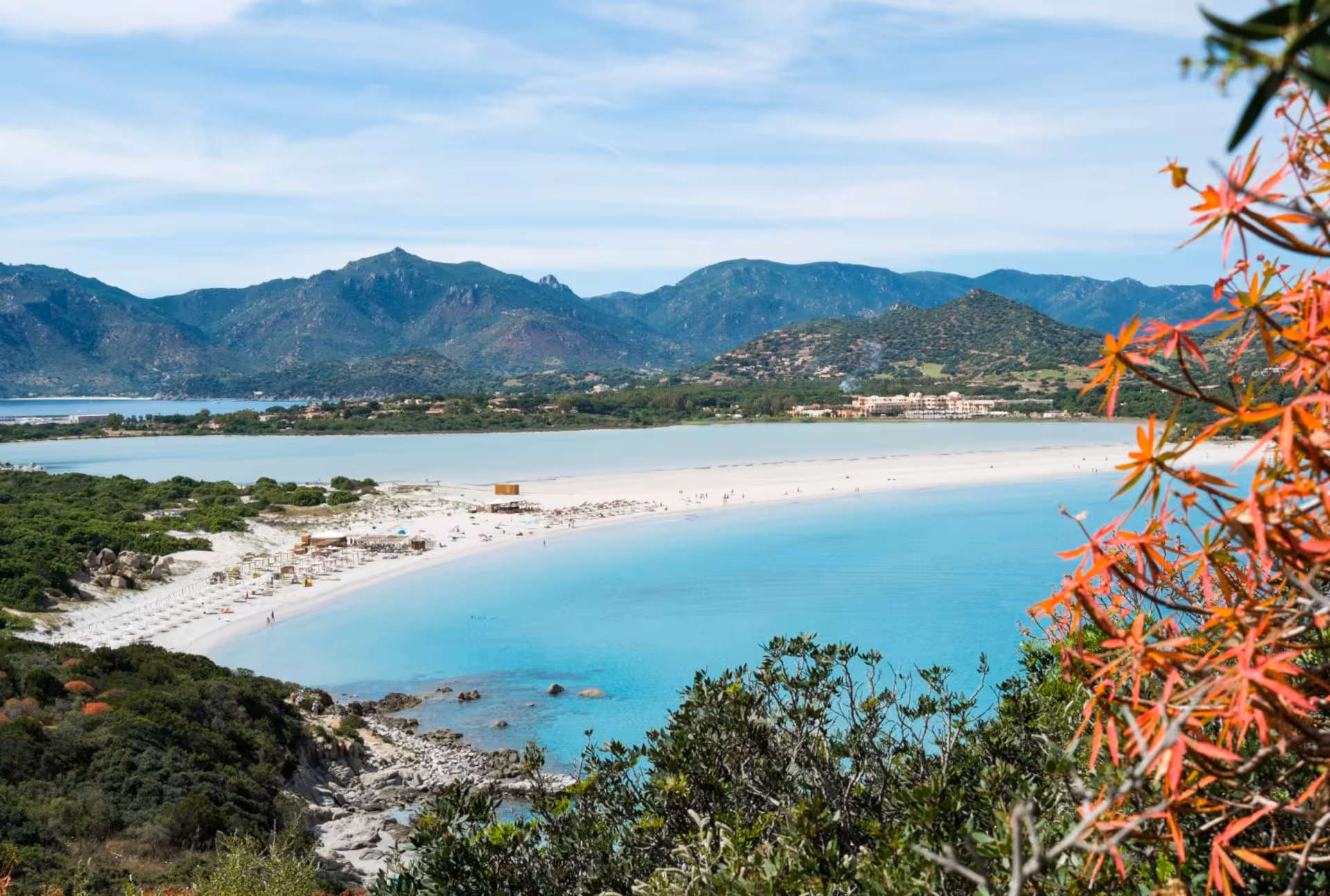Breathtaking Villasimius coastline with vibrant flowers and clear waters, ideal for Cagliari beach excursions.