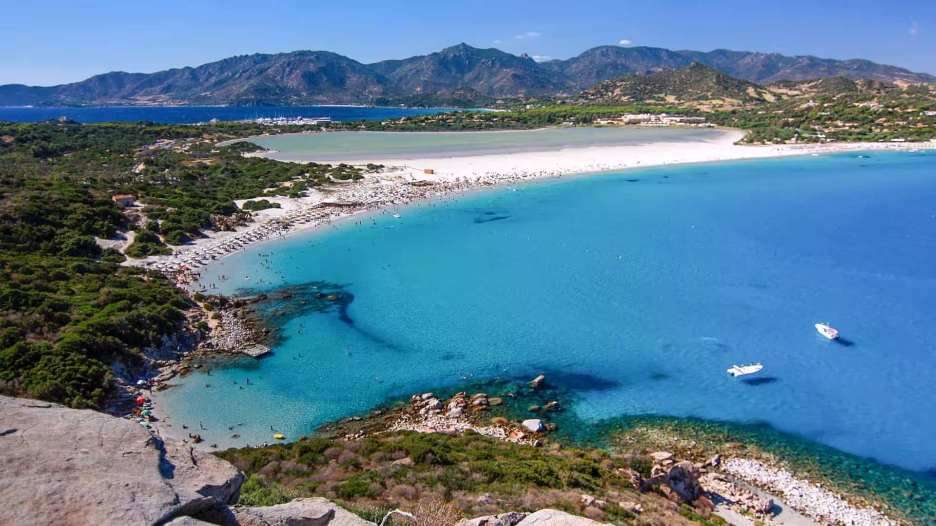 Stunning aerial view of Villasimius beach with turquoise waters and lush greenery, perfect for Cagliari tours.