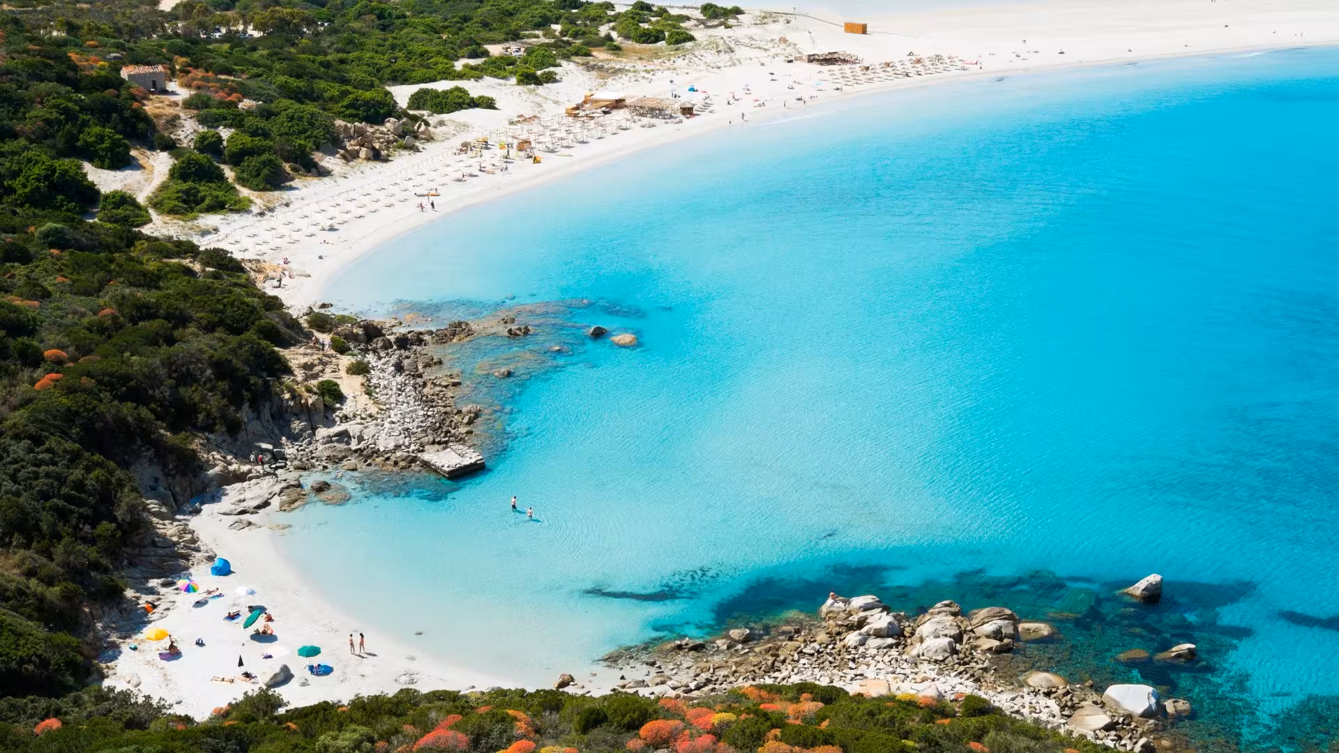 Aerial view of Villasimius' pristine turquoise waters and sandy beaches, ideal for a Cagliari coastal tour.
