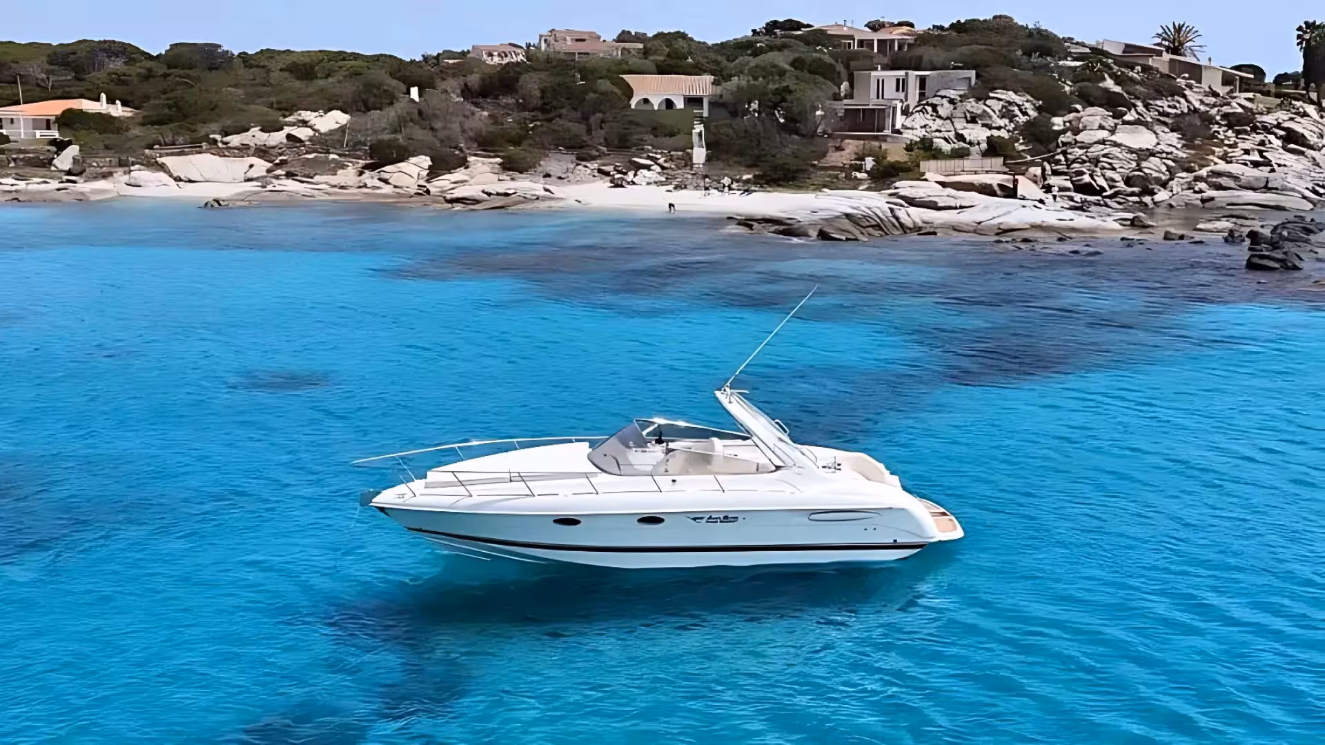 Elegant white speedboat floating in clear turquoise waters near Villasimius, ideal for private tours.