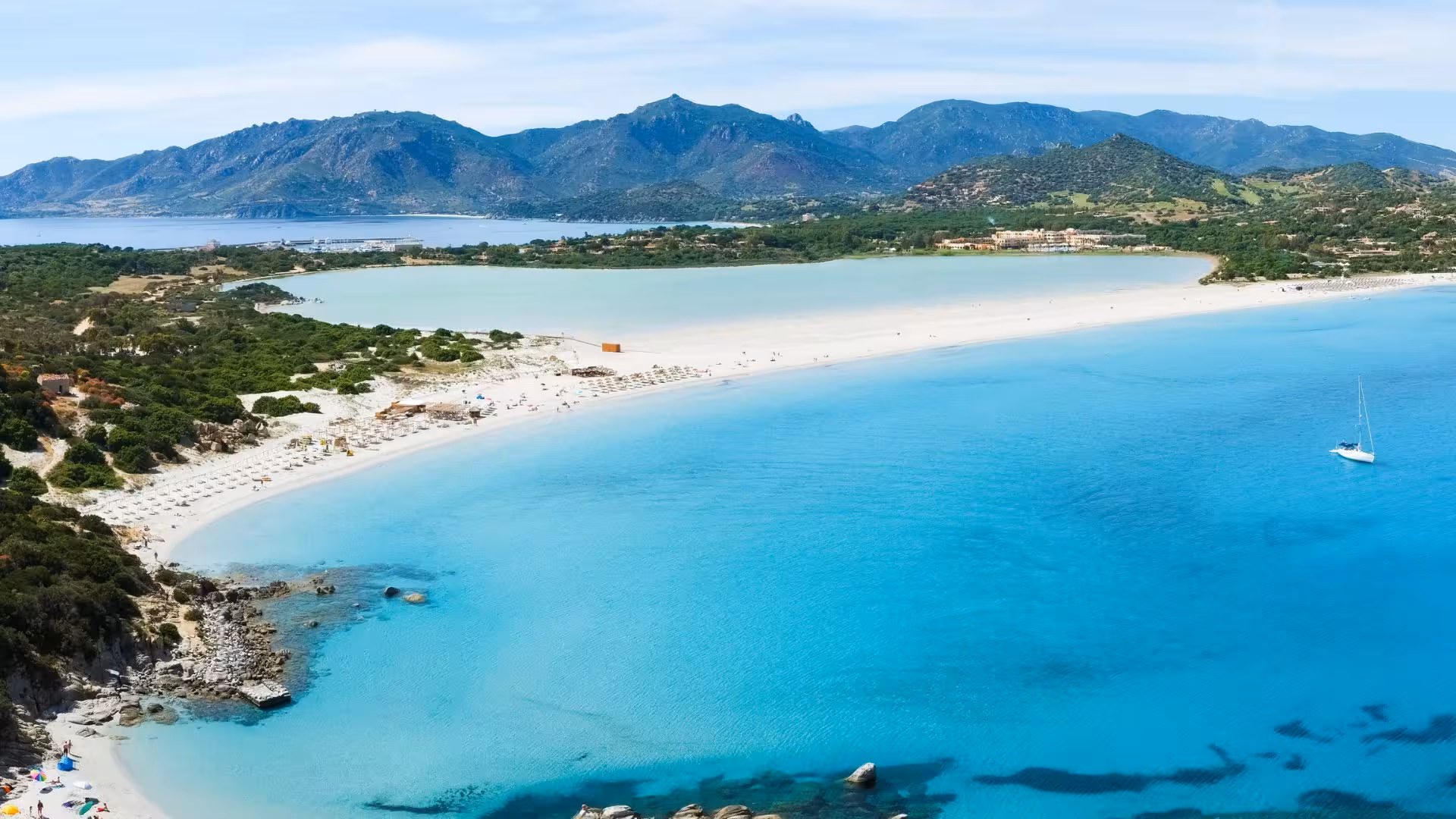 Stunning aerial view of Villasimius beach with turquoise waters and lush landscapes, ideal for private tours.