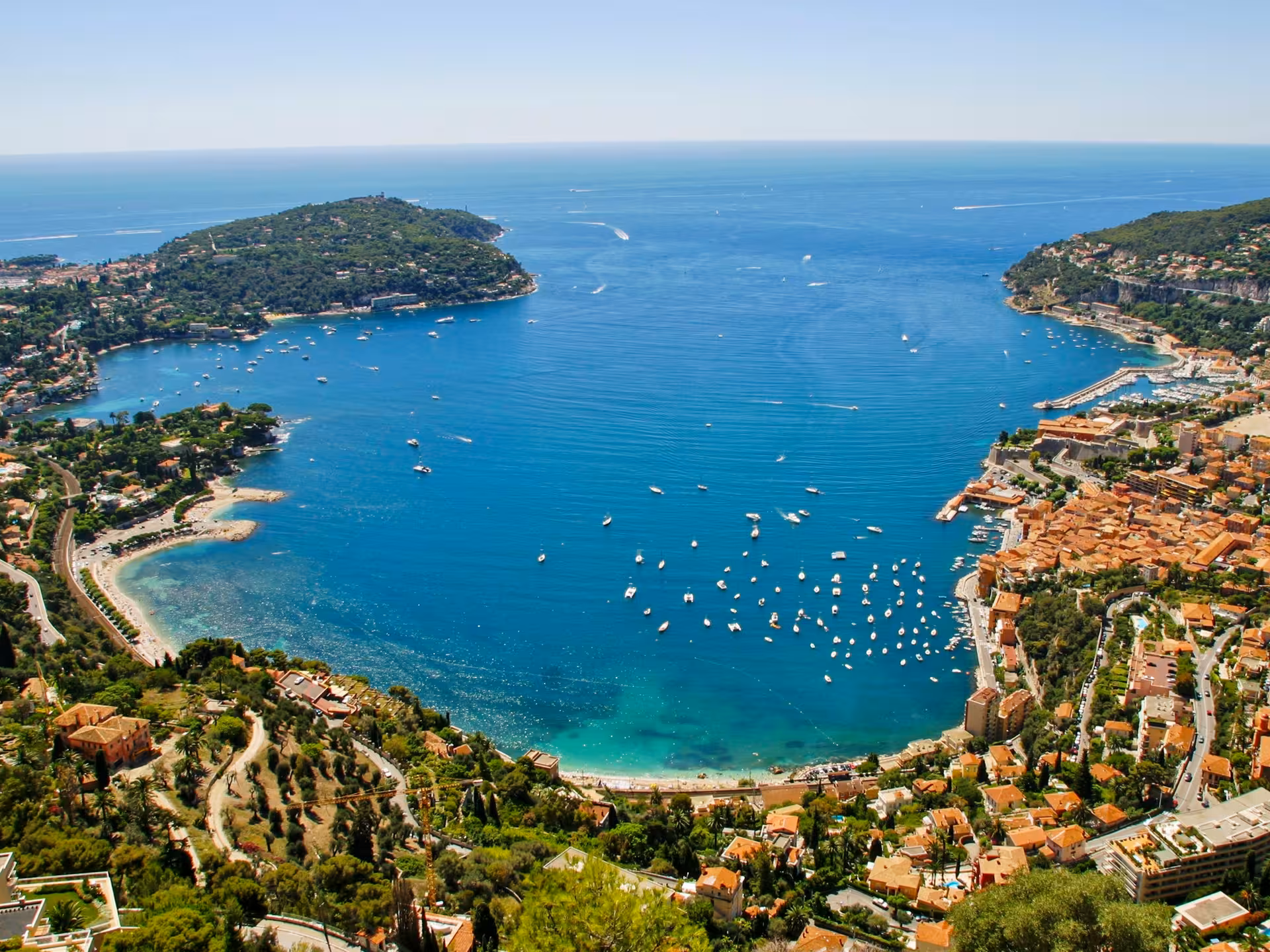 Aerial view of Villefranche-sur-Mer bay near Nice with turquoise Mediterranean waters and terracotta rooftops