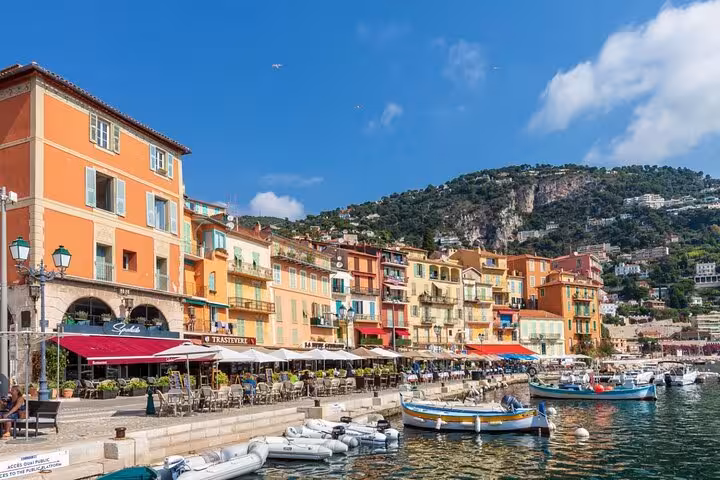 Colorful waterfront buildings and boats at Villefranche-sur-Mer harbor near Cap Ferrat, French Riviera