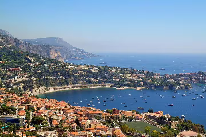 Panoramic Villefranche-sur-Mer bay with boats and hillside villas on a private French Riviera highlights tour