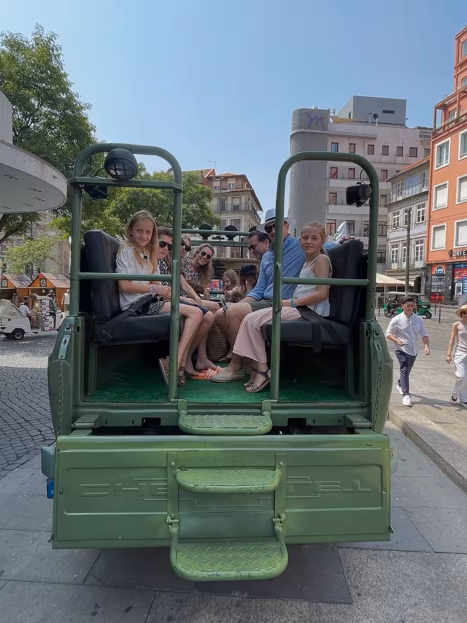 Guests riding in an open-top vintage car in Porto city center on North Coast Adventure tour