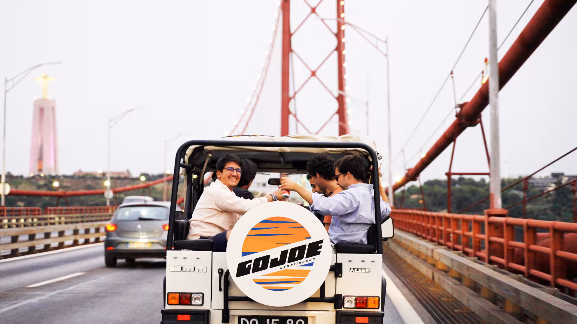 Vintage Jeep crossing Lisbon’s 25 de Abril Bridge on a daily tour with local food and drink tastings