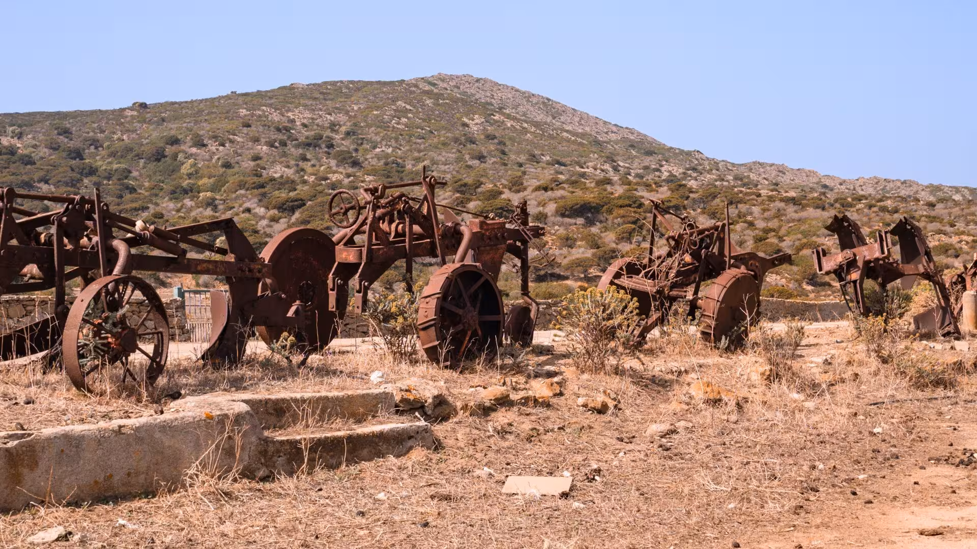 Rusty vintage tractors in Asinara Island's rugged landscape, highlighting the island's rich agricultural history.