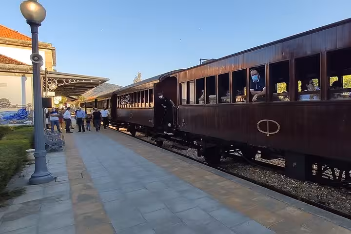 Historic vintage train at a scenic Portuguese station stop during a Douro River boat tour excursion
