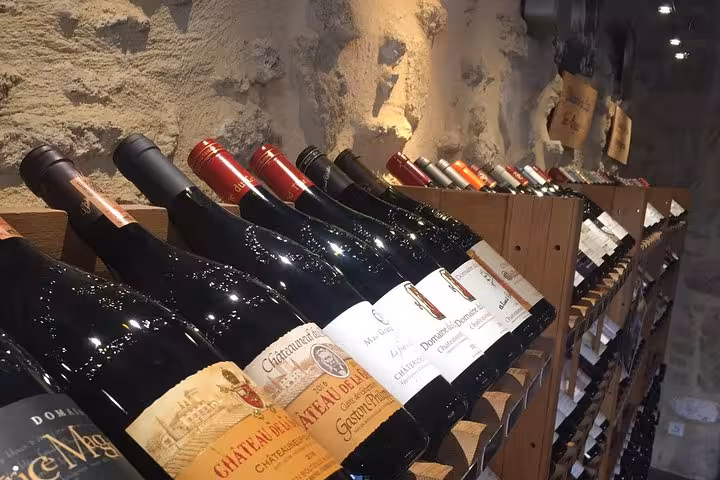 Rows of vintage wine bottles aging in a stone-walled cellar, highlight of the 3-day heritage, wines and gastronomy tour