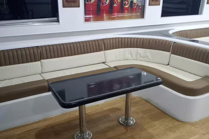 Modern VIP boat indoor seating area for Hurghada Dolphin House and snorkeling day trip, roomy cabin lounge