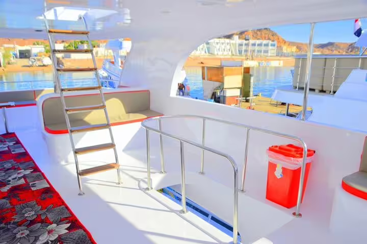 VIP boat deck with ladder and railings near marina, used for Private VIP Snorkeling tour to Ras Mohamed and White Island