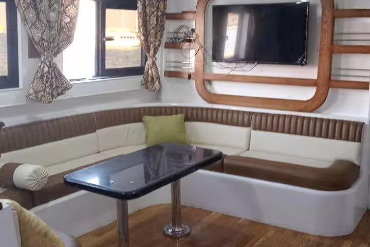 VIP boat lounge seating and table for Hamata Island snorkeling day trip from Marsa Alam, Red Sea