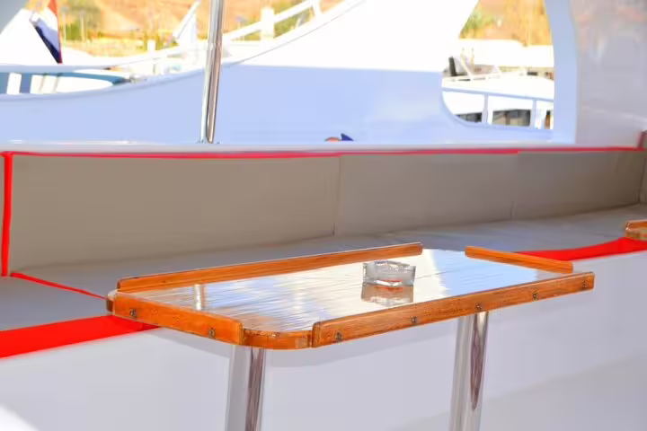 Comfortable VIP boat bench and table on Hurghada snorkeling and diving tour, Red Sea day trip
