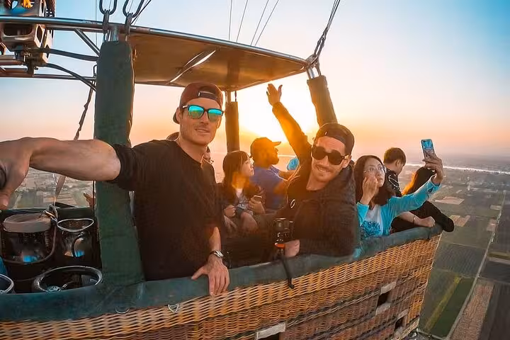 Guests in VIP hot air balloon basket at sunrise, Luxor full-day tour from Hurghada with aerial views