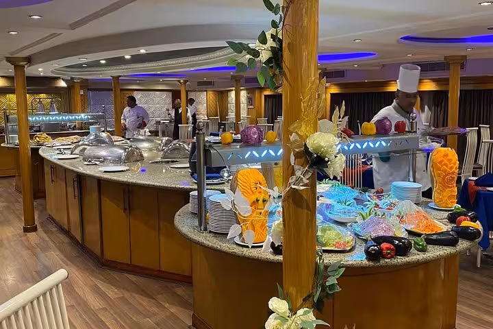 Onboard restaurant buffet with chefs and carved fruit, dining on a VIP 4-day 3-night private Nile cruise