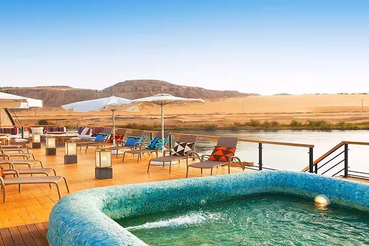 Luxury Nile cruise sun deck jacuzzi and loungers with desert panorama on VIP Aswan to Luxor private cruise