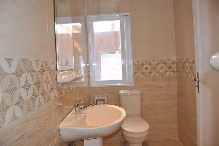 Clean private cabin bathroom with sink and toilet on a VIP 4-day 3-night Nile cruise from Aswan to Luxor