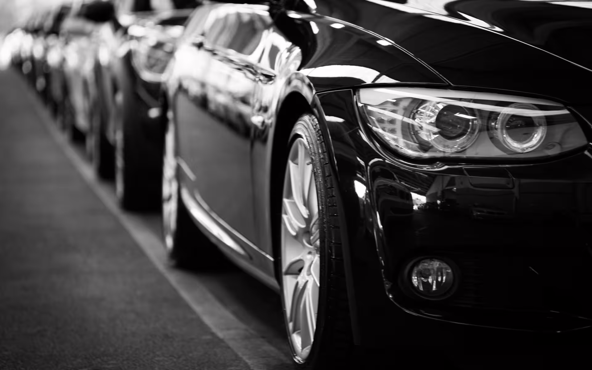 Row of sleek black executive cars ready at Civitavecchia cruise port for VIP private transfer from ship to Rome