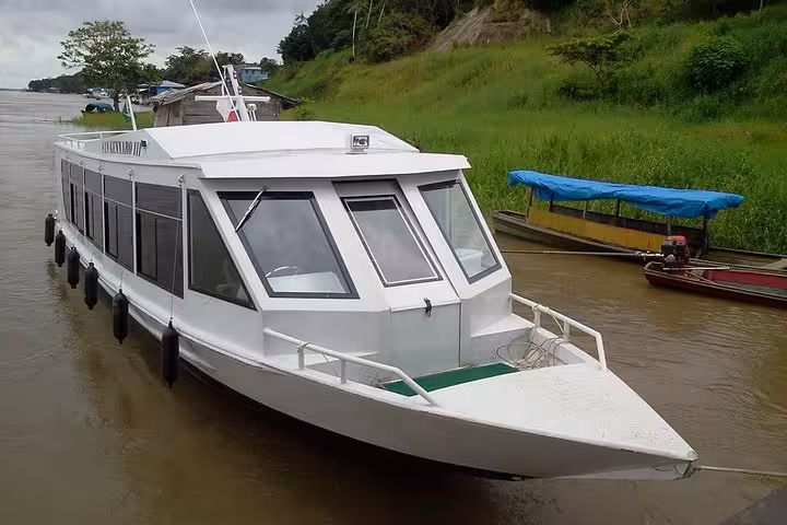 VIP covered speedboat docked on Amazon River near Santa Rosa Brazil border for Iquitos Peru transfer