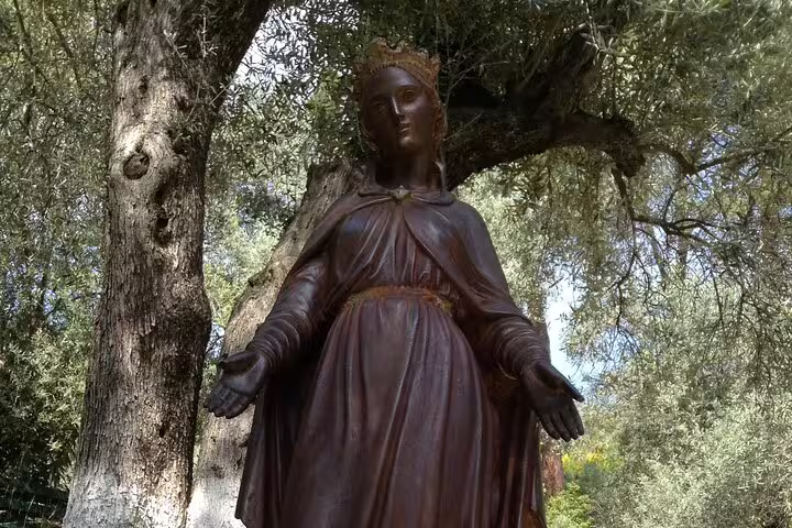 Bronze Virgin Mary statue beneath olive trees at House of the Virgin Mary, Ephesus tour stop