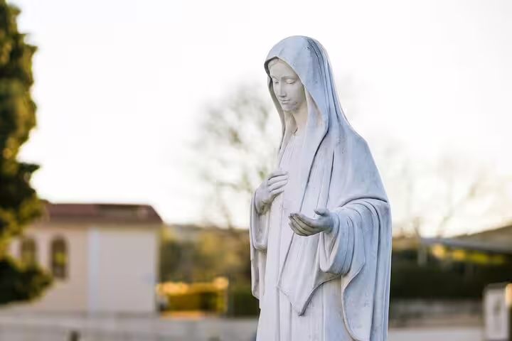 White statue of the Virgin Mary in Medjugorje, Bosnia, a serene highlight on a private pilgrimage tour