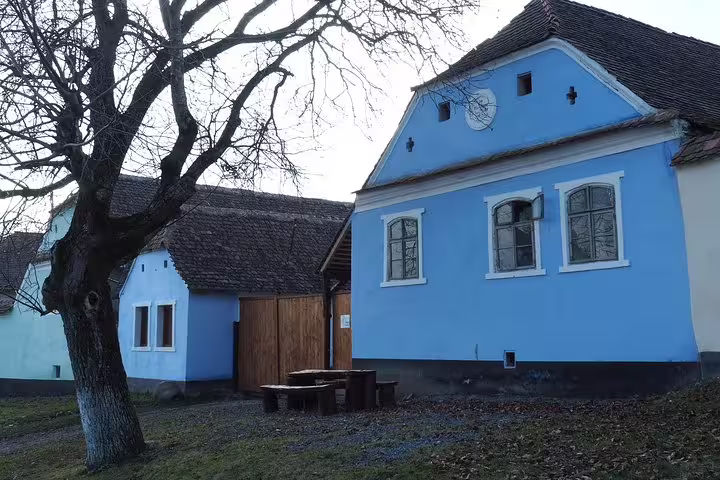 Blue traditional Saxon house with wooden gate in Viscri village, Transylvania