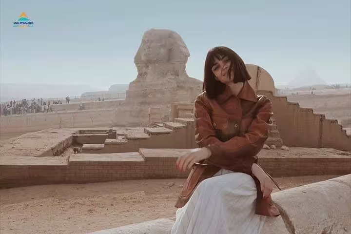 Visitor posing by the Great Sphinx at Giza Plateau, highlight of 2-day Giza and Cairo from Alexandria private tour
