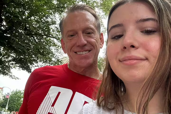 Two visitors smiling outdoors near trees during a self-guided tour of Philadelphia Independence Historical Park