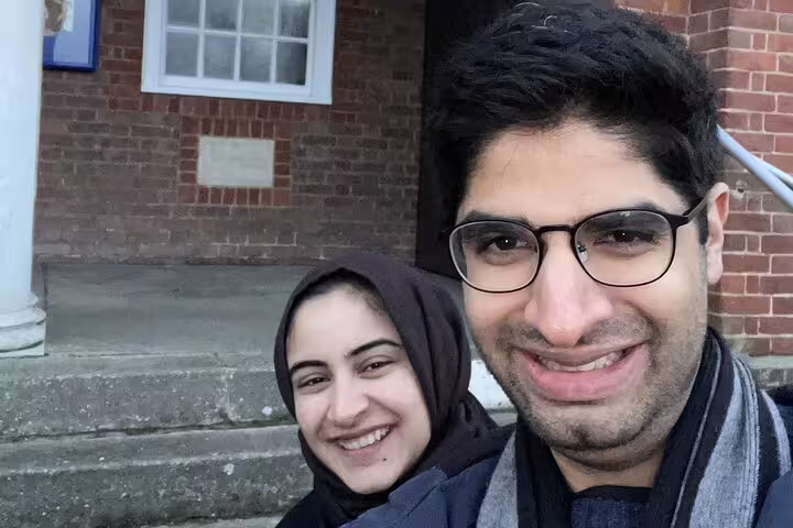 Two smiling visitors on a self-guided walking tour in Letchworth Garden City