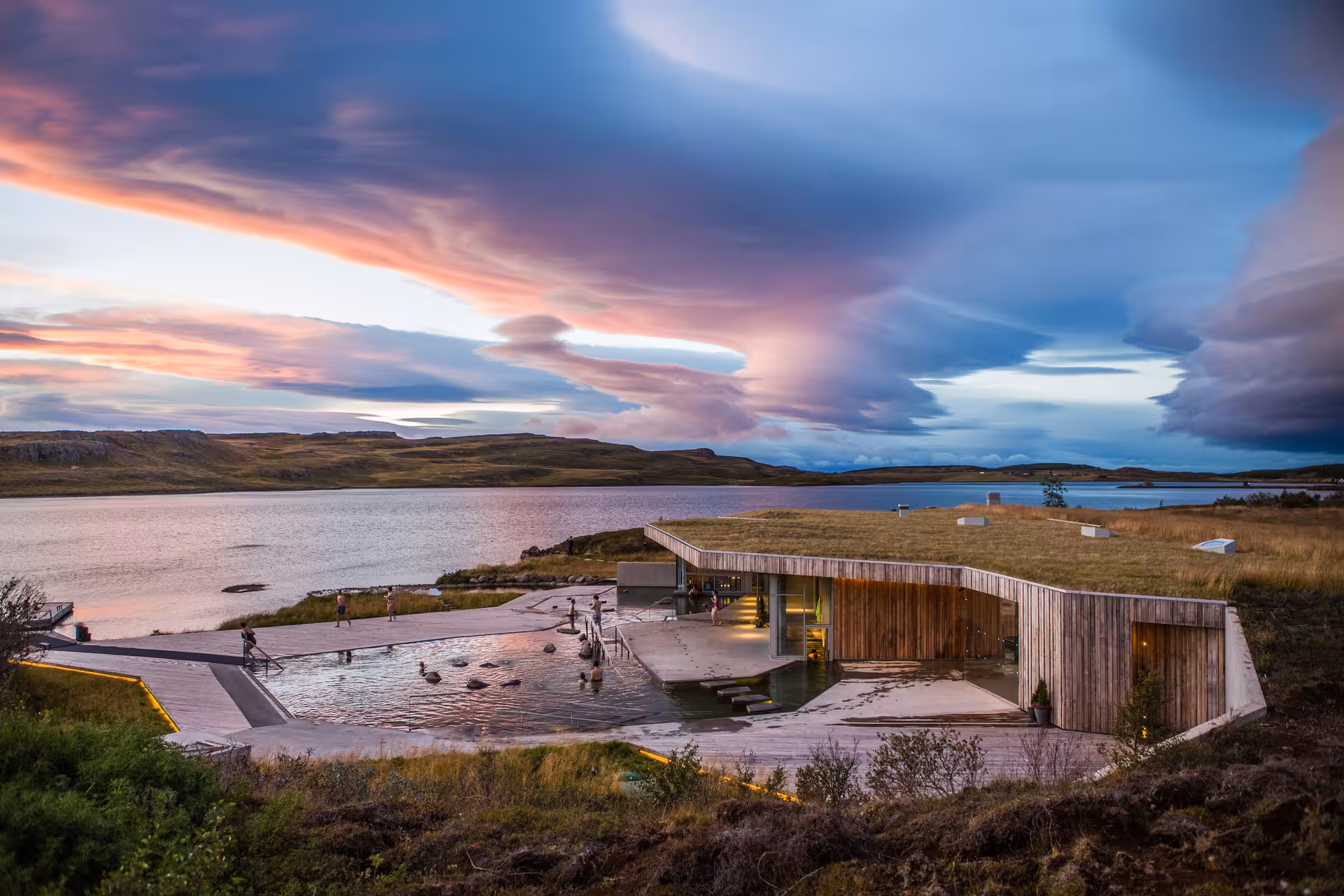 Vok Baths geothermal pools at sunset beside a calm lake in East Iceland