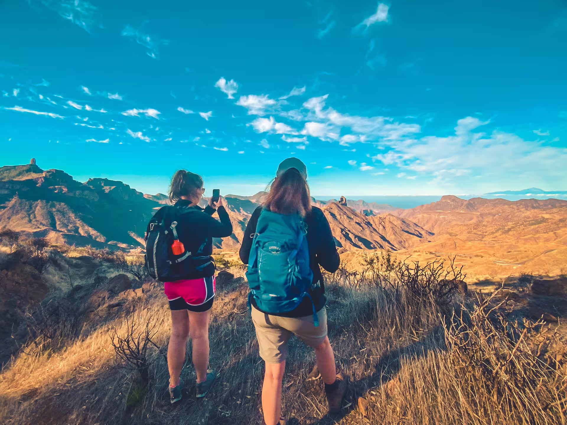 Hikers photographing stunning mountain landscapes on the Volcano Heart Tour, ideal for nature and photography lovers.
