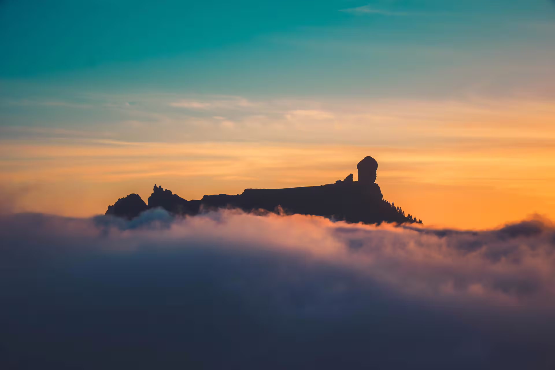 Stunning volcanic silhouette against a vibrant sunset, capturing the essence of the Volcano Heart Tour experience.