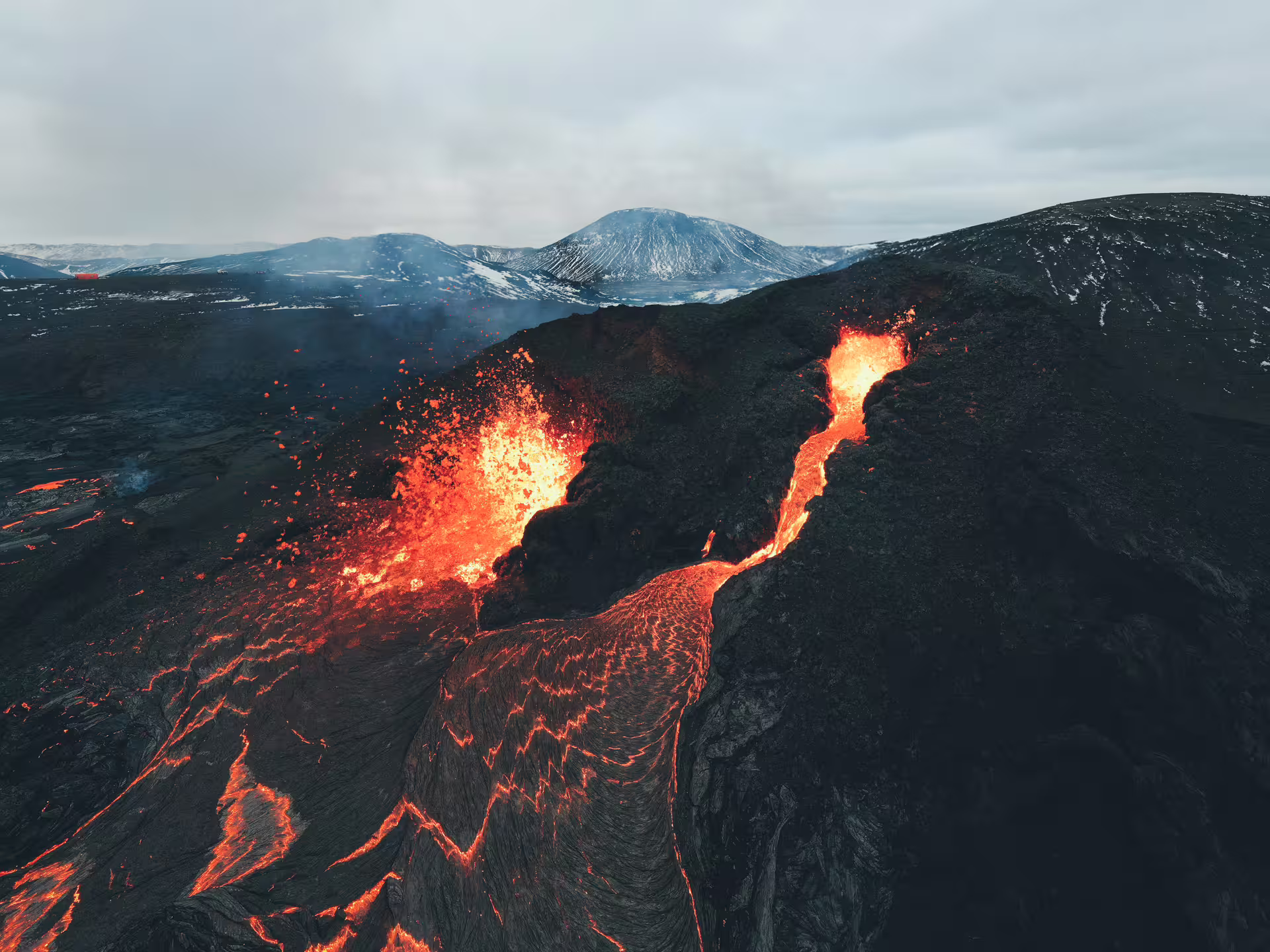 Active lava fountains and glowing lava flows on volcanic landscape near Reykjavik, Iceland