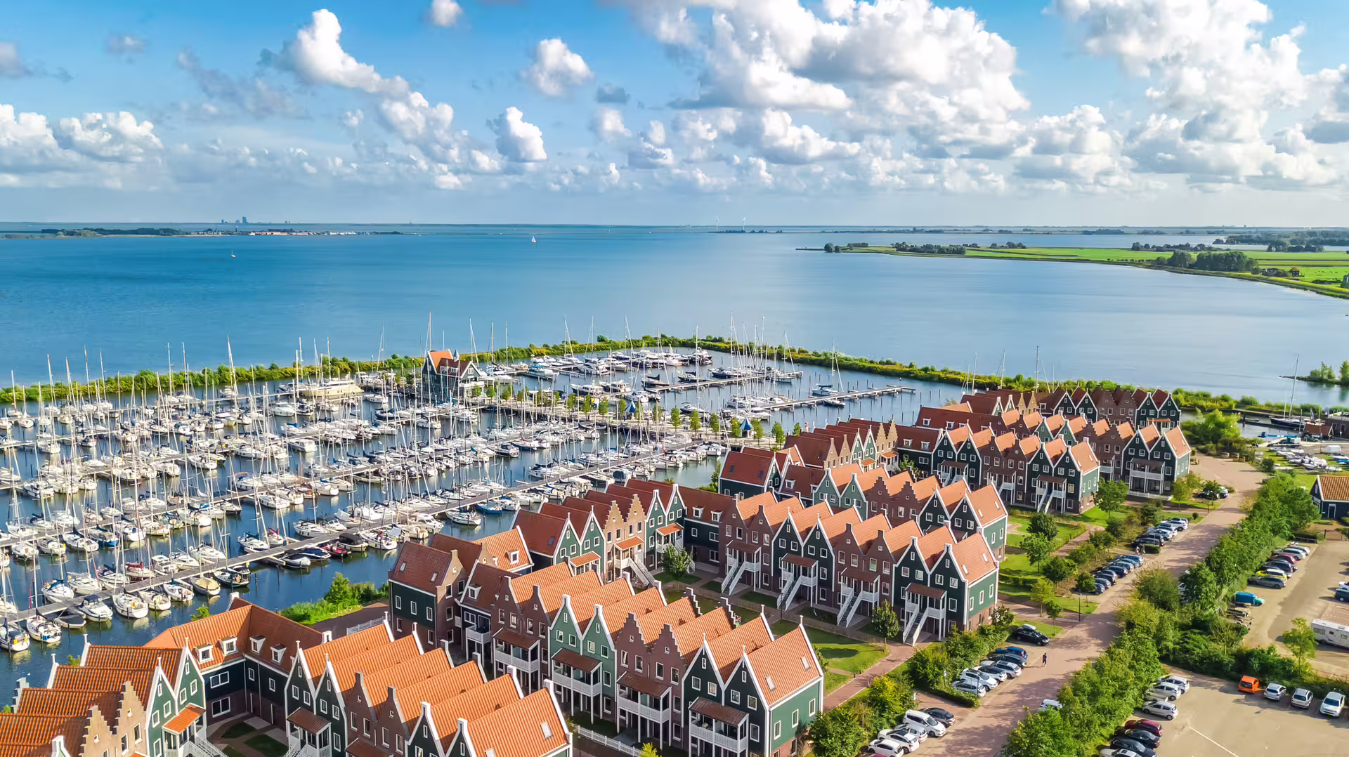 Aerial view of Volendam marina and colorful Dutch houses on the Markermeer, ideal for a 1-day audioguide walk
